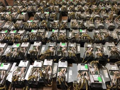 Vast rows of Bitcoin mining rigs housed in a large-scale mining farm