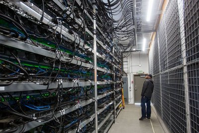 A large mining farm with rows of ASIC miners.
